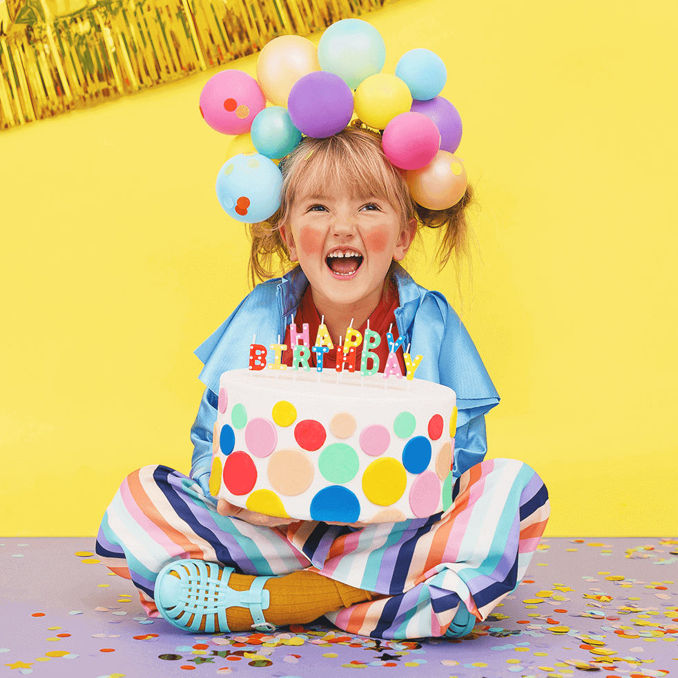 child holding birthday cake with happy birthday inscription